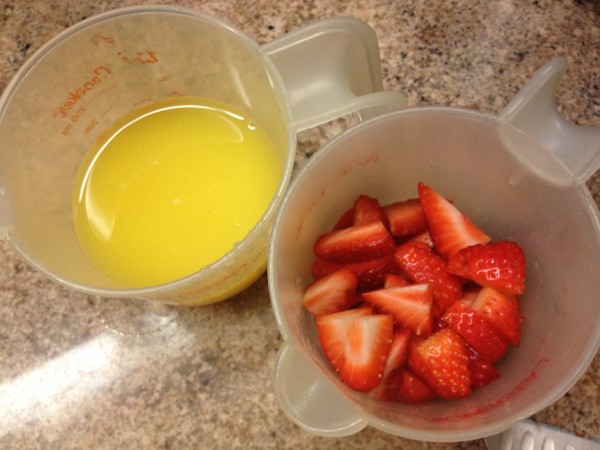 strawberries. orange juice. the makings of fruit snacks.